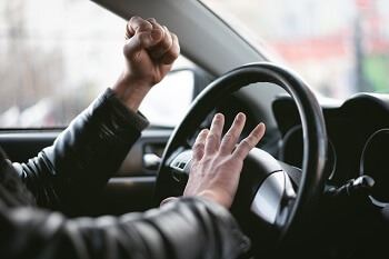 Man Aggressively Honking Car Horn